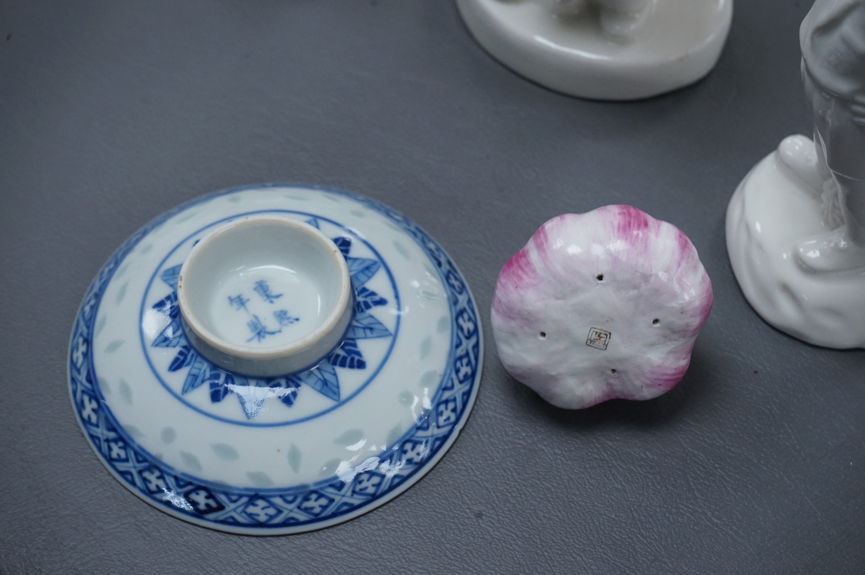 Four Chinese blanc de chine figures and two blue and white dishes and a model of a garlic bulb. Tallest figure 17.5cm.